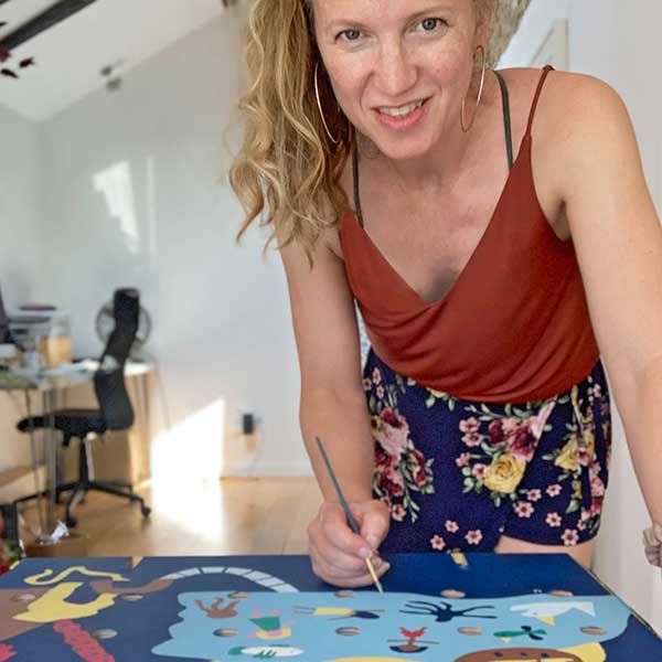 Amanda Rigby artist painting a mural in her home studio